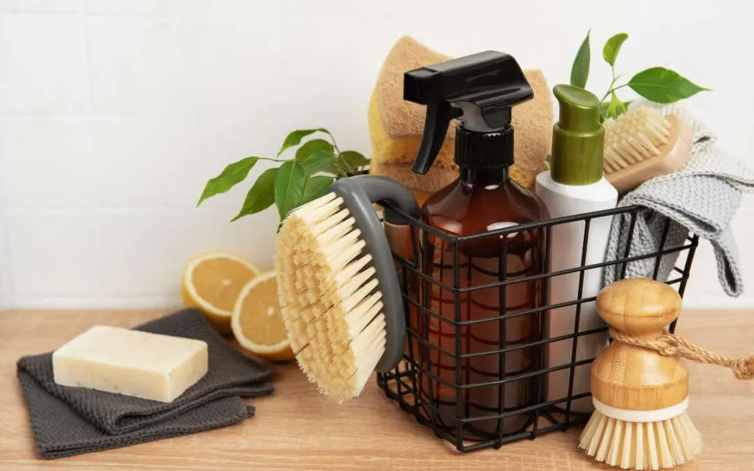 Natural cleaning supplies, including brushes, spray bottles, and lemons, are arranged neatly in a basket.