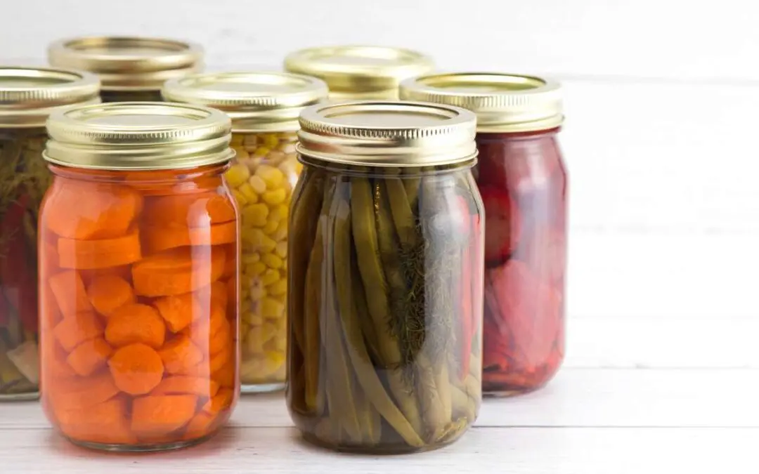 An assortment of various fruits and vegetables that have been canned at home.