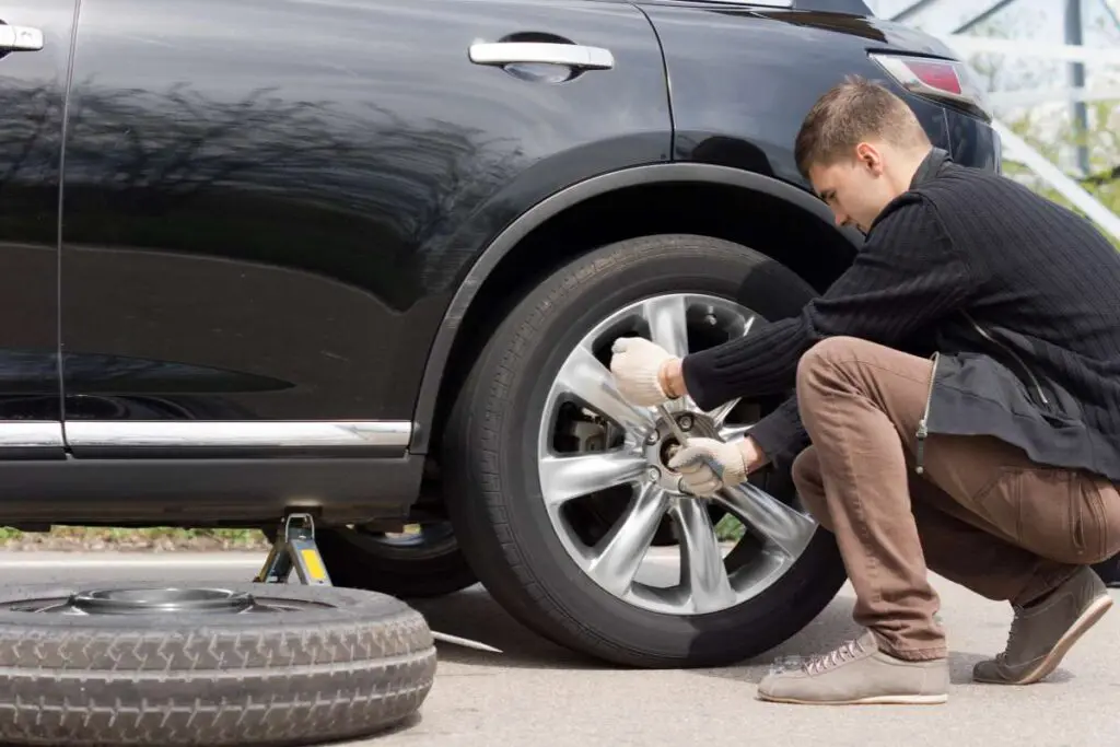 Man changing his spare wheel.