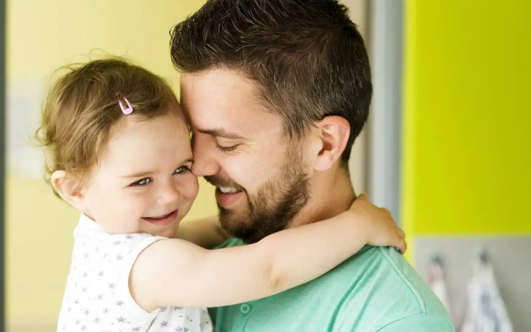 A man is holding a baby.