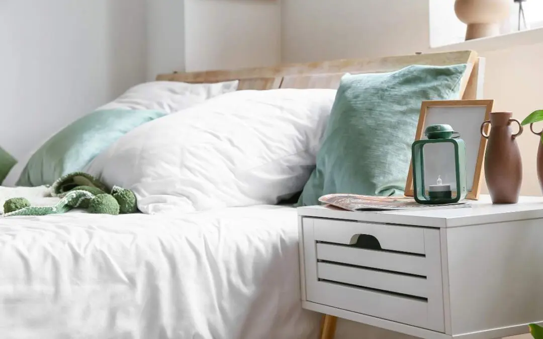 A neatly made bed with soft pillows, a bedside table featuring decorative items.