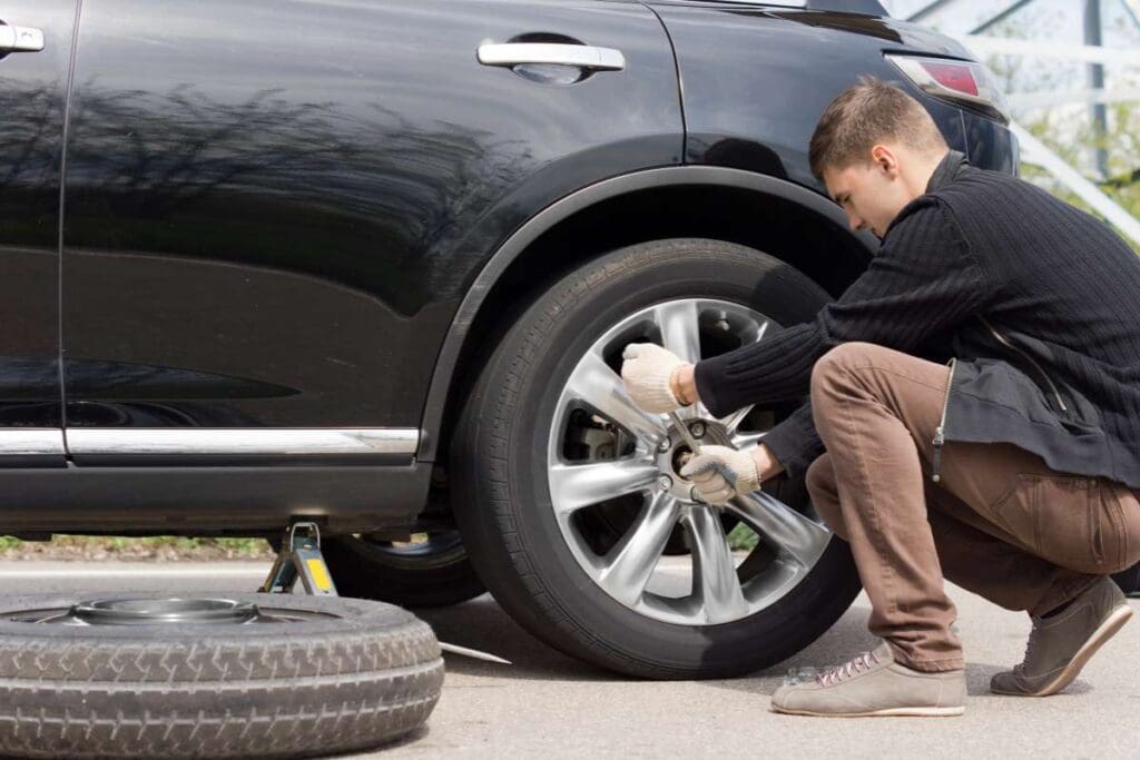 Man changing his spare wheel.
